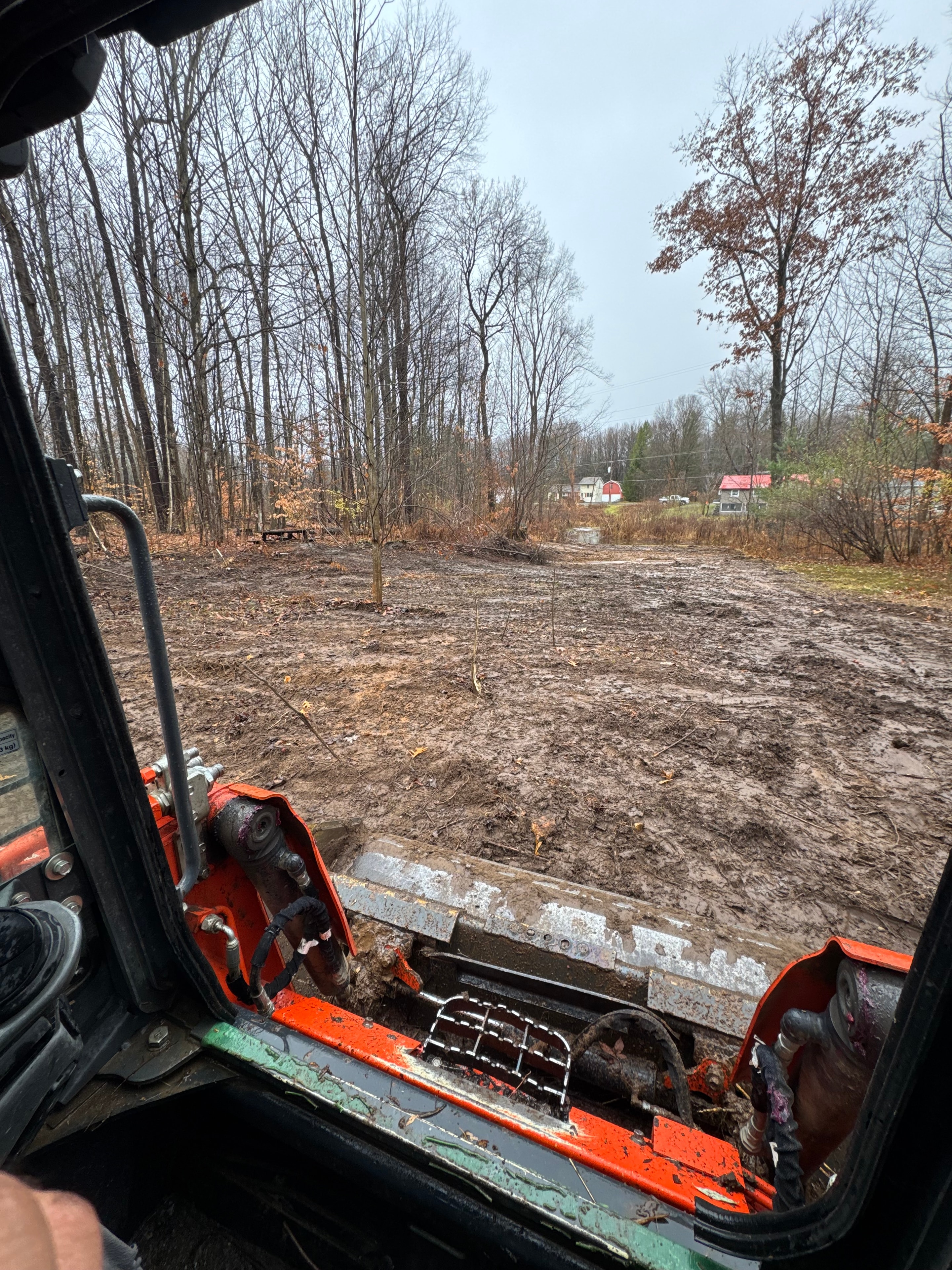 Land clearing in progress from equipment cab