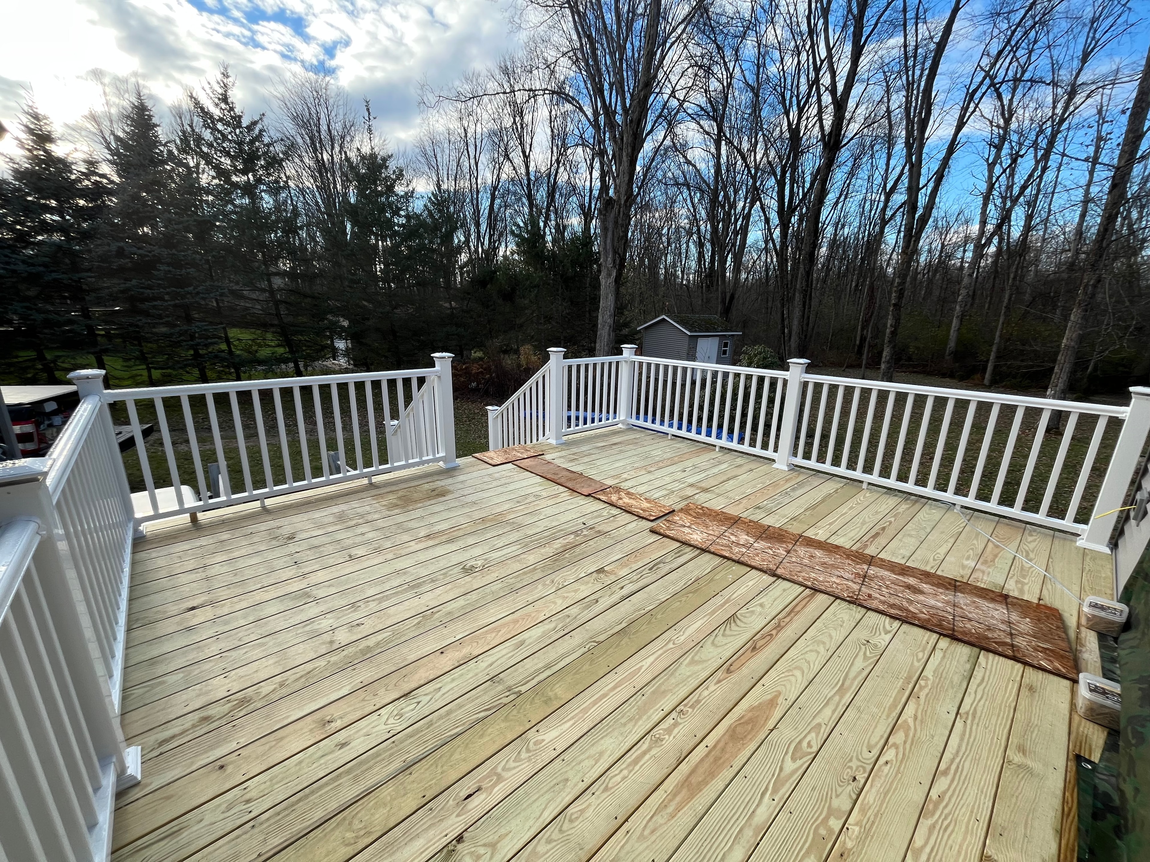 New pressure-treated deck with white vinyl railing