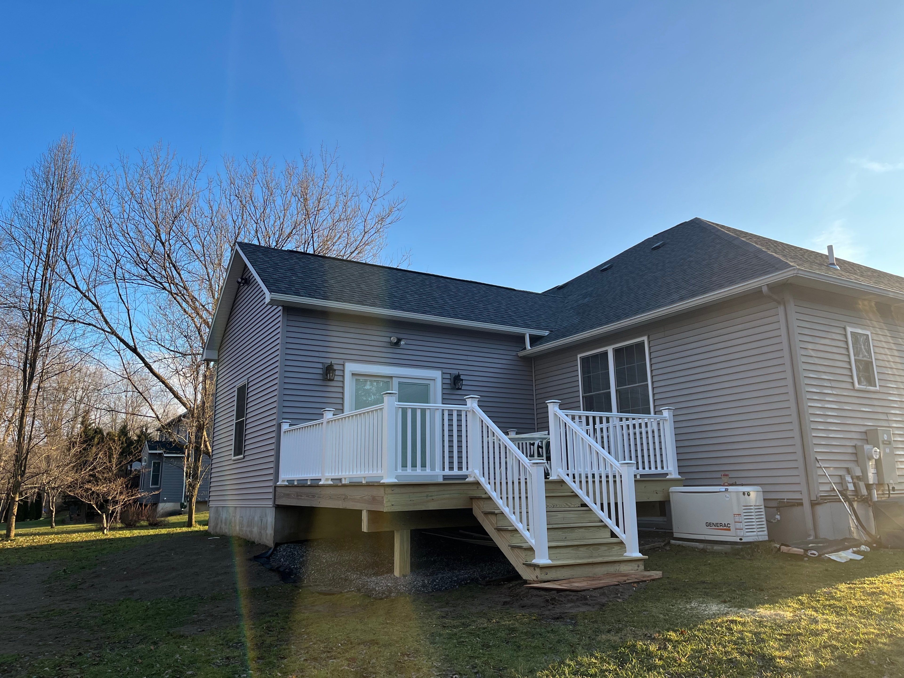 Completed deck with stairs on back of home