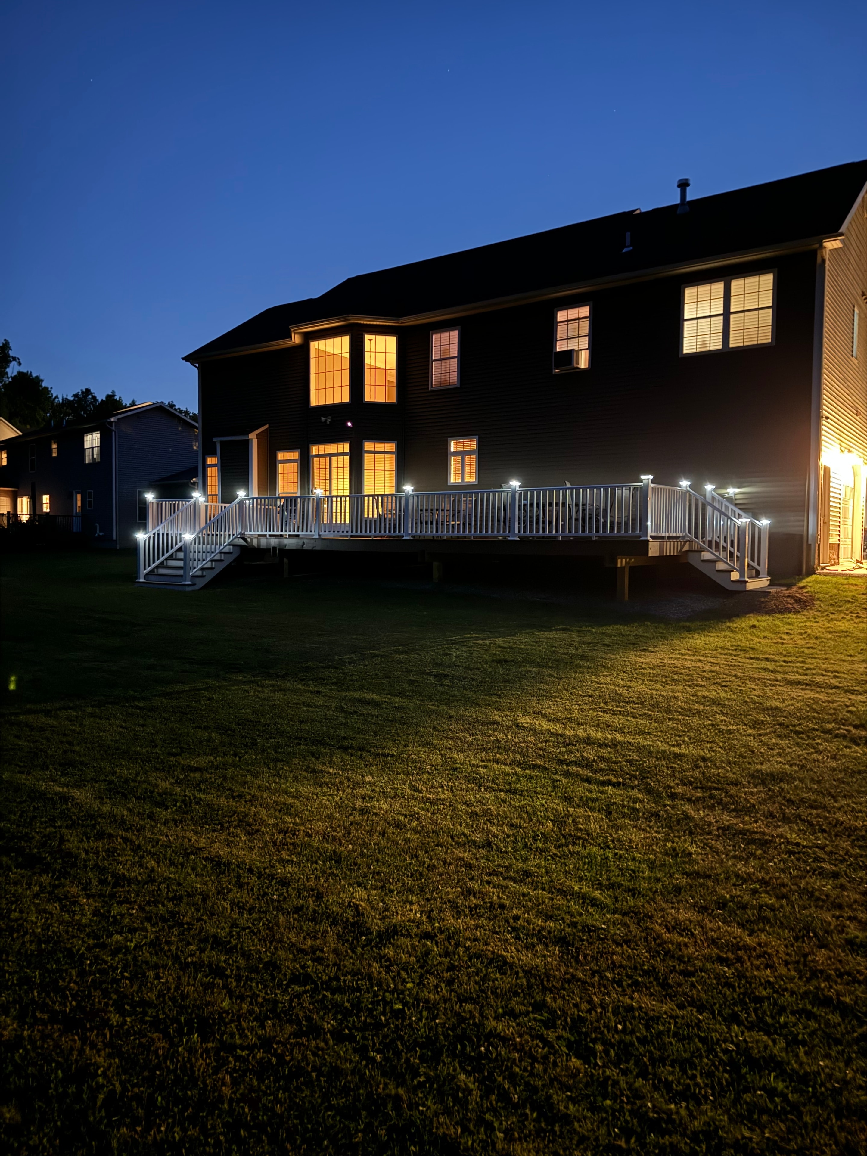 Large deck with lights glowing at night