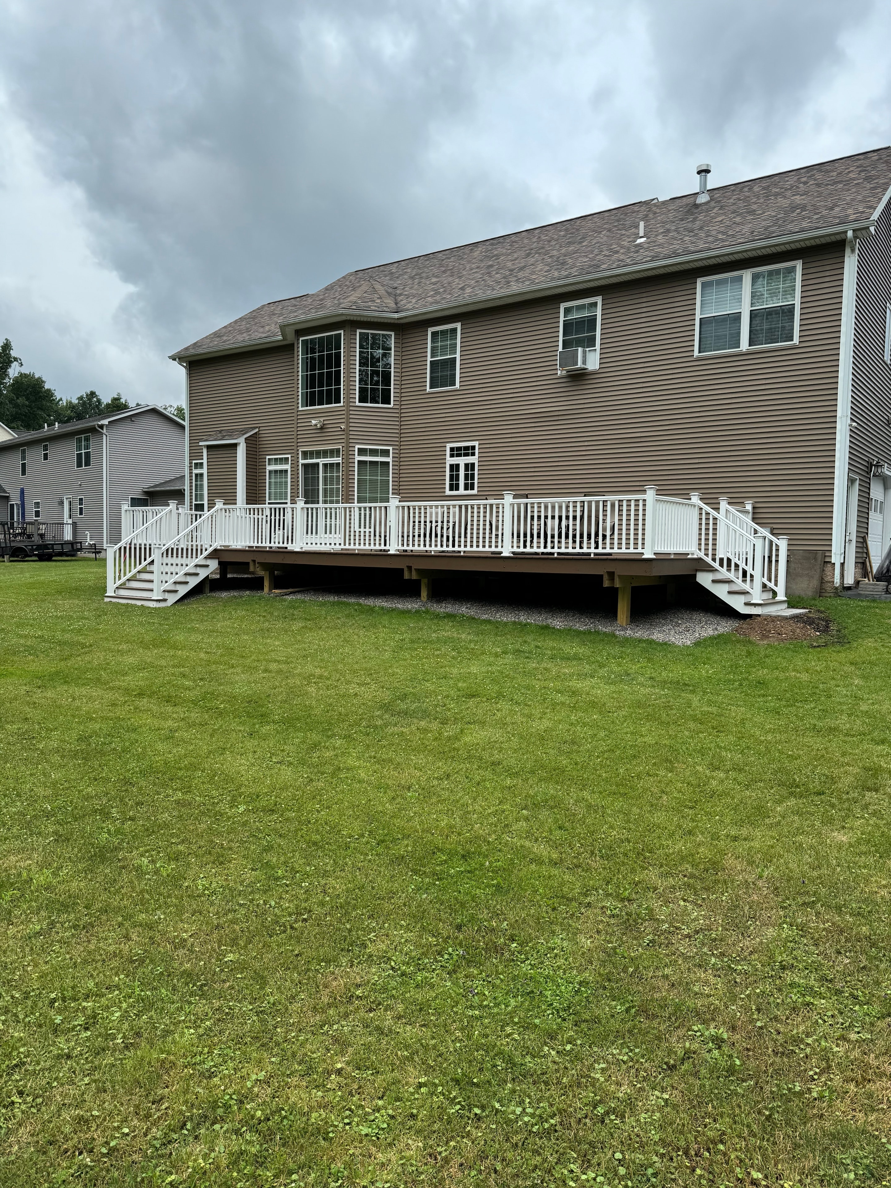 Large deck with white railing, daytime view