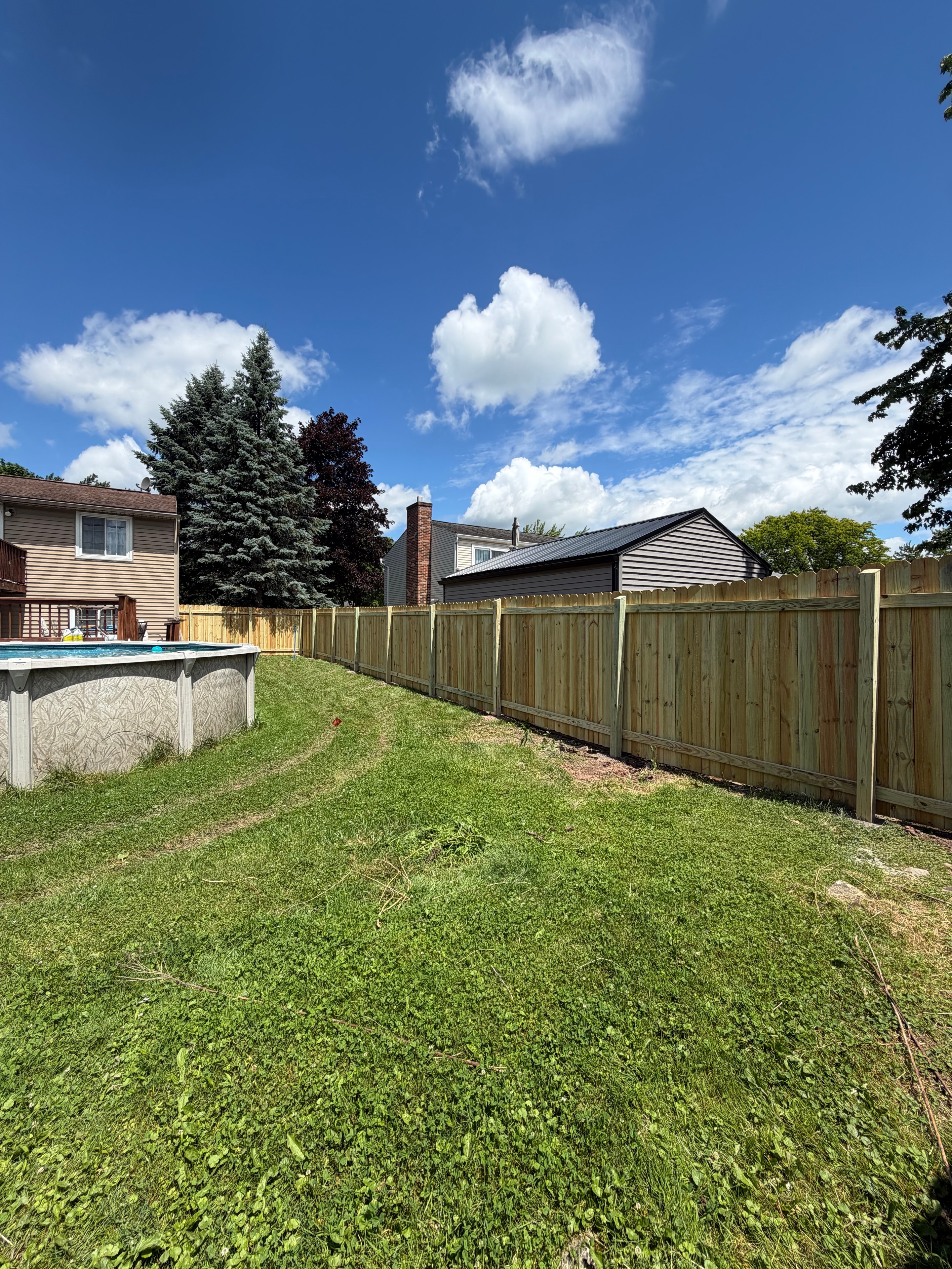 New fence with pool and blue sky